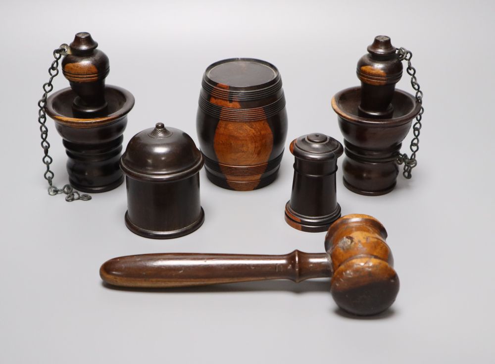 A group of 19th century lignum vitae objects: A pair of whistles and holsters, a match holder with go-to-bed, a model barrel, 9cm, a ga